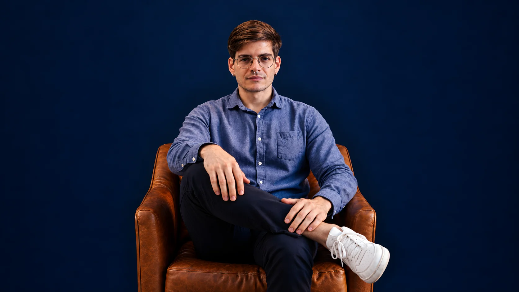 Felipe Levi seated in a brown leather armchair